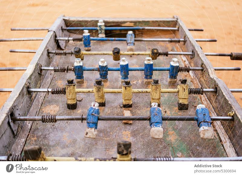 Metal old foosball table with yellow and blue figurines football soccer game play miniature rust sahara mauritania africa metal bar player old fashioned toy