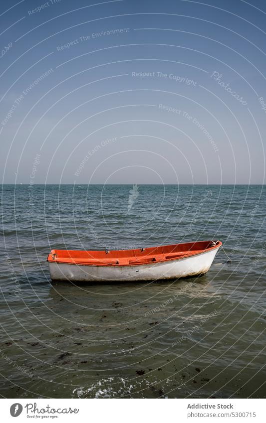 Boat floating on rippling sea boat water nature summer ripple marine seascape sky cloudless vessel daytime bright ocean wooden nautical transport calm