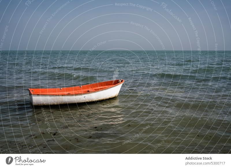 Boat floating on rippling sea boat water nature summer ripple marine seascape sky cloudless vessel daytime bright ocean wooden nautical transport calm
