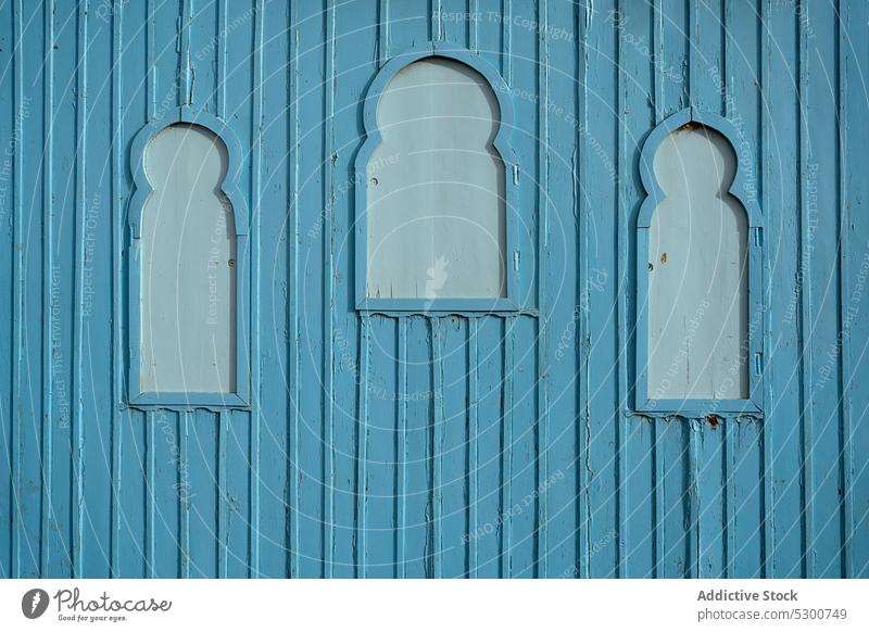 Blue wooden wall with windows plank building street decorative texture panel board shabby blue mauritania paint timber background old structure weathered