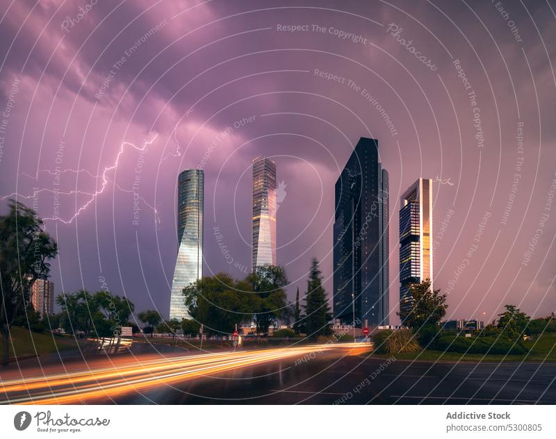 Lightning over modern skyscrapers in cloudy sky city evening cityscape building lightning urban madrid spain architecture cuatro torres four towers