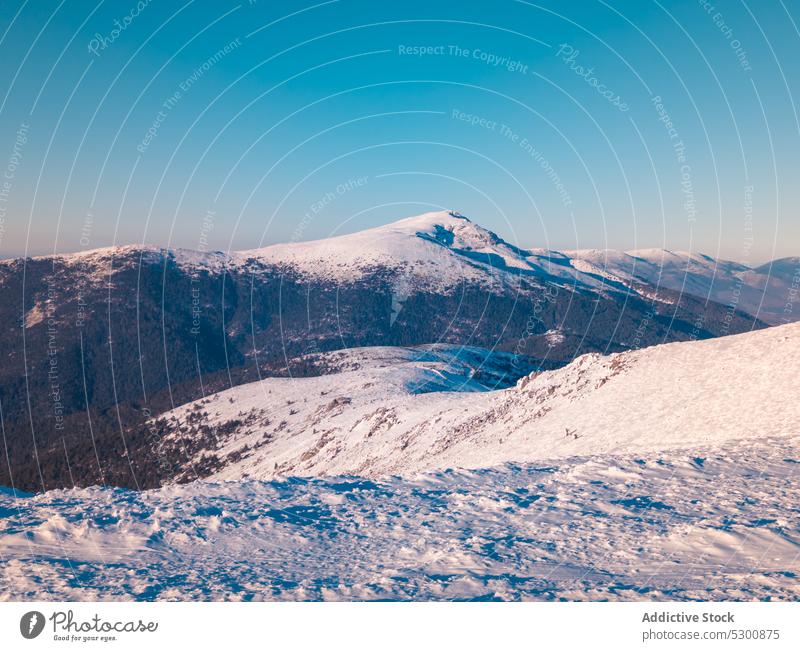 Snowy mountains against blue sky winter range landscape snow nature hill highland cold scenic peak bola del mundo mountain spain evening picturesque scenery