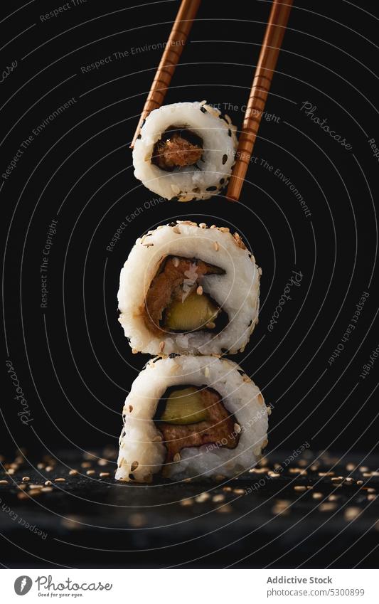 Delicious sushi rolls with chopsticks sesame asian food seafood appetizing cuisine meal tradition stack tasty gourmet delicious seed dish oriental fresh serve