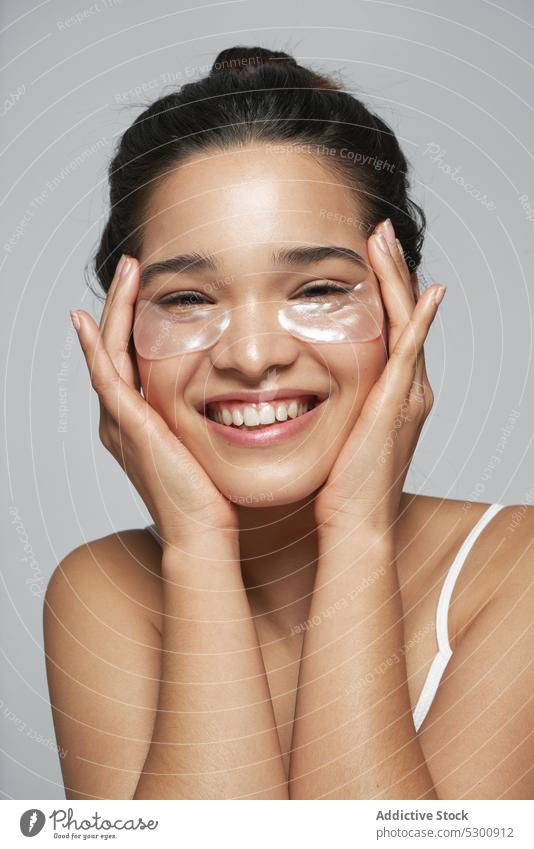 Charming woman with eye patches skin care calm portrait facial tranquil relax serene rest peaceful female treat spa cosmetology cosmetic wellness human face