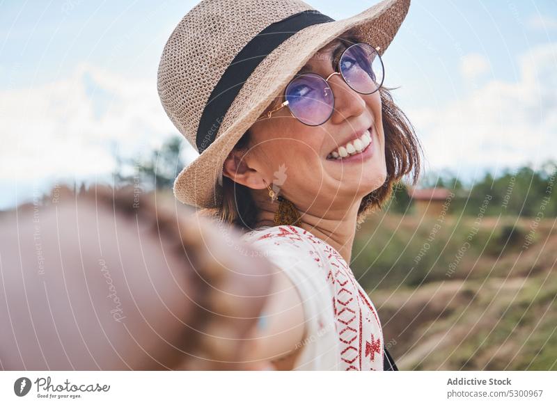 Positive traveler with boyfriend in desert area woman holding hands follow me happy smile love straw hat tourist vacation tatacoa desert colombia couple