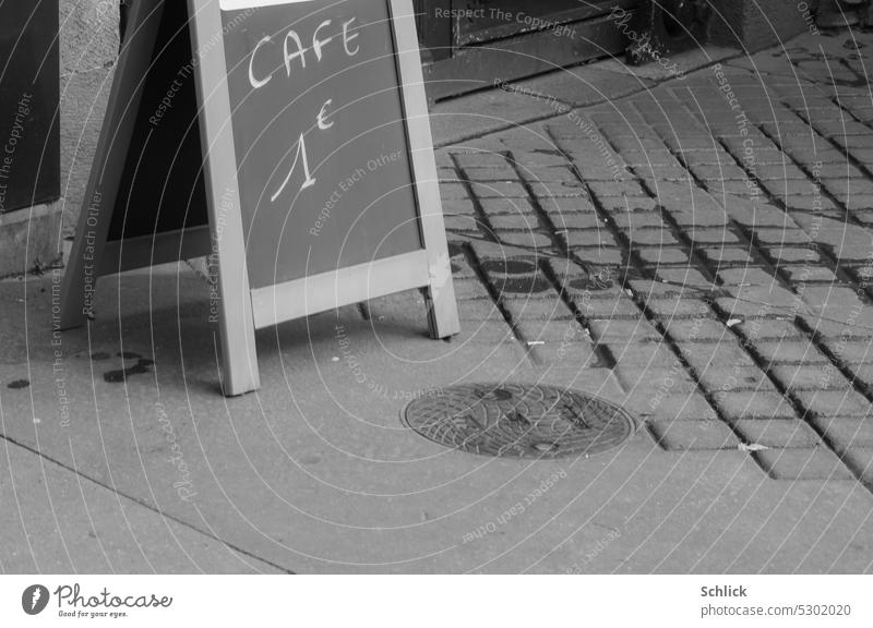 Paris ! Street sign Blackboard Coffee Cheap street coffee Asphalt Text writing Black & white photo manhole cover Entrance Signs and labeling Exterior shot