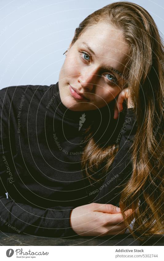 Calm woman looking at camera dreamy model turtleneck carefree lean on hand portrait appearance style studio calm long hair female young charming personality