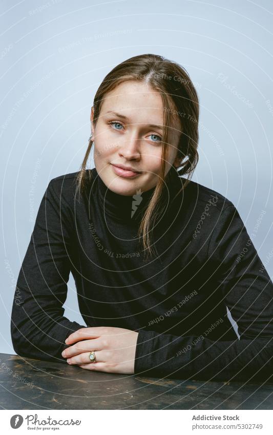 Calm woman looking at camera dreamy model turtleneck carefree portrait appearance style studio calm female young charming personality feminine individuality