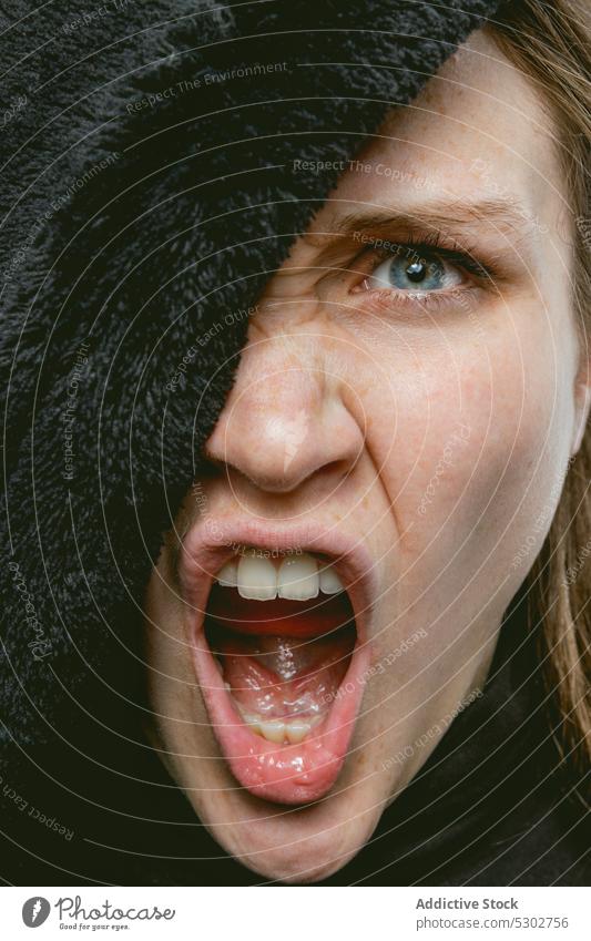 Angry woman screaming in studio cover face angry expressive portrait make face irritate annoyed female young shout lady yell model blue eyes mouth opened