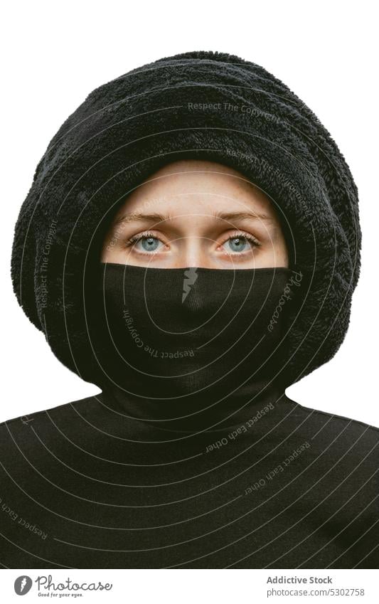 Calm woman in headscarf in studio serious model style portrait hat fashion confident individuality appearance female young hide cover face turtleneck