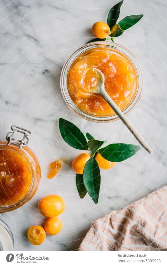 Glasses of kumquat jam with fruits fig jar fresh healthy glass table spoon vitamin natural citrus nutrition ingredient diet food delicious tasty vegetarian
