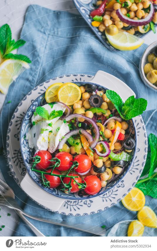 Healthy salad with tomatoes and lemon slices chickpea herb vegetable healthy delicious fresh plate diet tasty organic dish food meal nutrition vegetarian lunch