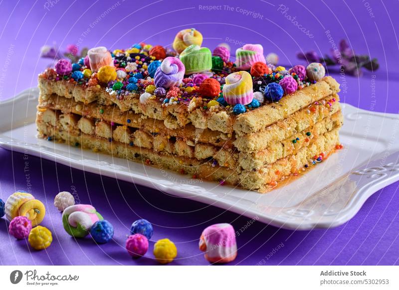 Delicious cake with colourful curly icing cream nougat peruvian homemade dessert baked pastry decoration colorful delicious caramel sugar confetti celebrate