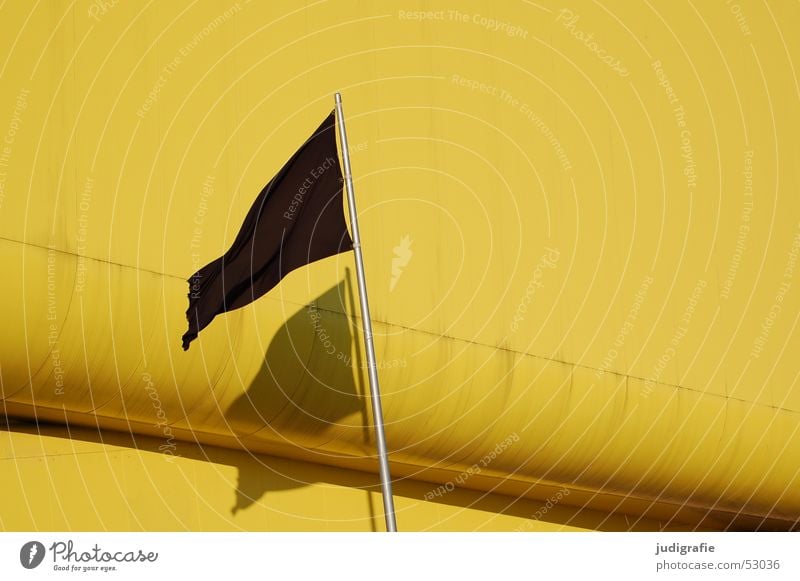 Black flag with shadow in front of yellow building Flag Yellow Light Hannover Flagpole Building Pavilion Lithuanian Pavilion Modern Shadow World exposition