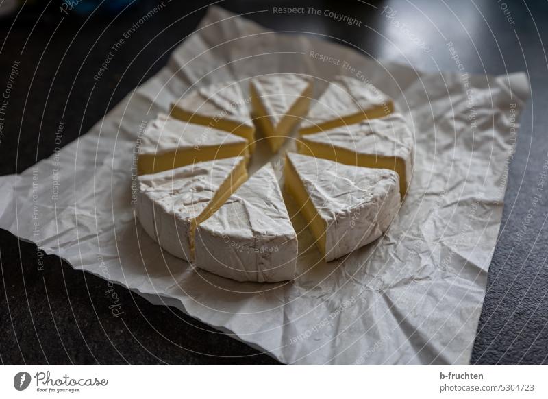 Camembert cheese cut into small cheese wedges Cheese Nutrition Cheese corner piece of cheese pieces camembert Paper Packaging Open Cut Gourmet Delicious Snack