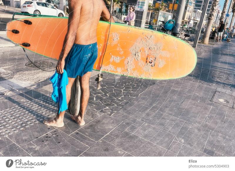Man in swimming trunks carries orange surfboard Surfboard Surfer Carrying Orange Summer vacation Hose urban Street Sports Beach Surfing Lifestyle
