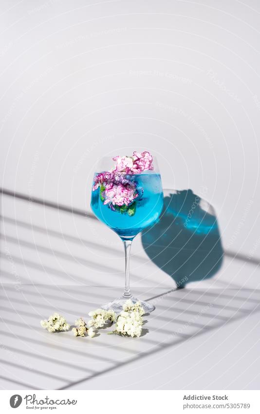 Glass of cocktail with flowers glass fresh mint drink leaf alcohol transparent composition beverage refreshment bright bloom liquid aroma natural colorful