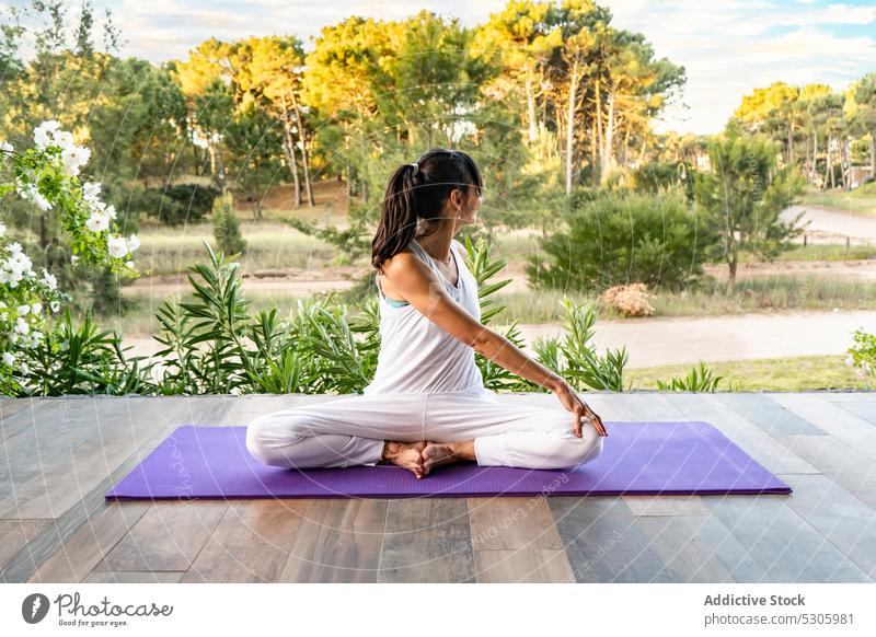 Faceless woman practicing meditation in nature yoga seated twist practice asana park wellness parivritta sukhasana forest activewear female pinamar buenos aires