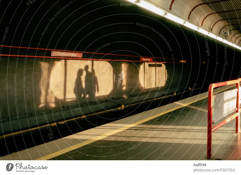 urban shadow play of passers-by on the stop Donauinsel Shadow play Silhouette Subway subway line Danube Island Vienna Capital city Light Colour photo background