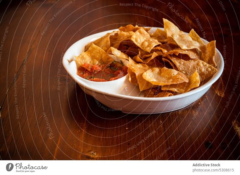 Mexican corn chips with salsa sauce background bowl crust cuisine eat eating flour food fried gourmet meal mexican mexico plate rustic served snack spicy table