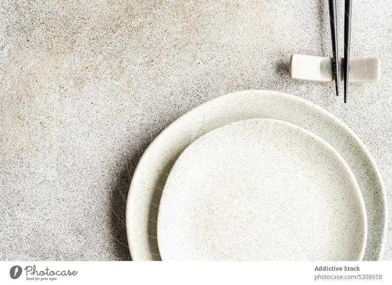 Minimalistic table setting on concrete background asia asian chopstick cutlery diet dinner eat eating food meal minimal minimalism minimalistic place plate