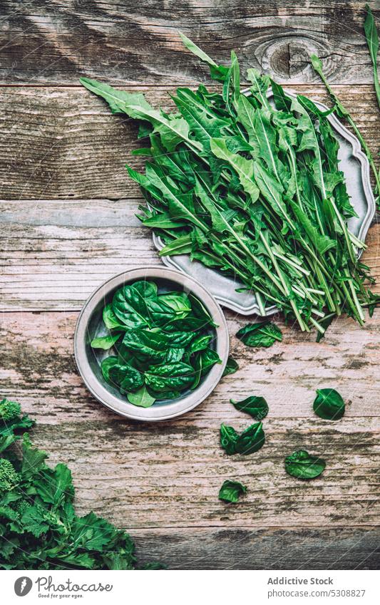 Fresh green lettuce leaves placed on wooden table leaf bowl salad food ingredient organic fresh cook kitchen healthy food herb prepare vegetable natural
