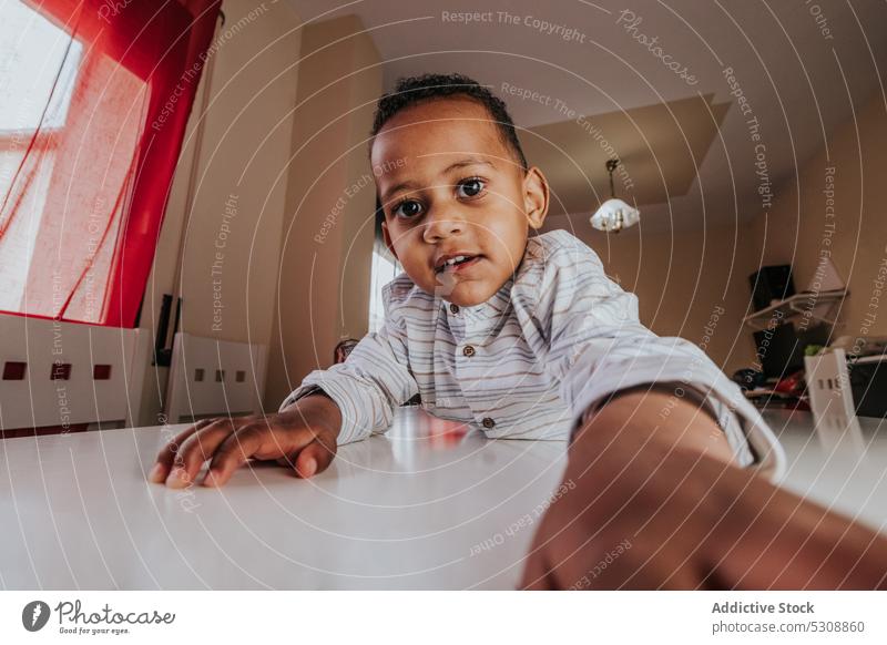 Cute boy taking selfie on smartphone toddler cellphone self portrait relax day off at home curious child black african american ethnic take photo capture moment