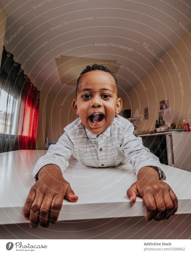 Adorable happy boy looking at camera toddler cute adorable child black african american ethnic satisfied relax pleasure enjoy morning little kid childhood