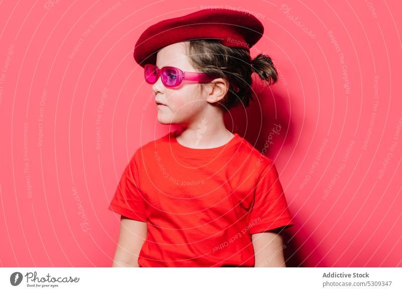 Girl in red casual shirt and beret looking away style kid girl trendy outfit fashion eyewear studio shot portrait little sunglasses cool isolated model
