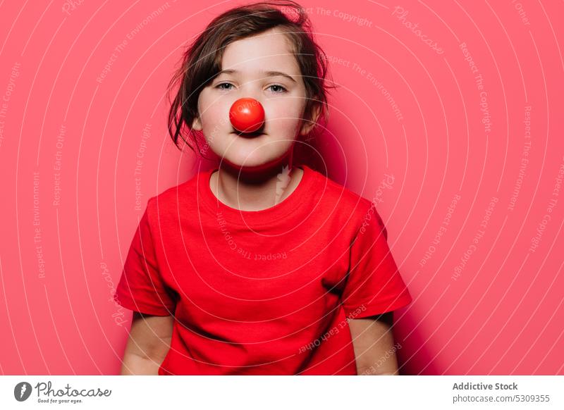Little girl in red casual dress with red over nose clown little child funny cute childhood innocent bright charming t shirt ripe portrait vitamin colorful