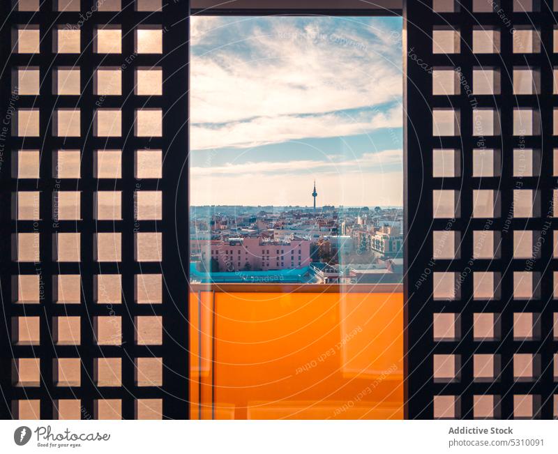 Modern glass window in building with view on city architecture residential cityscape street exterior facade structure urban district checkered construction town