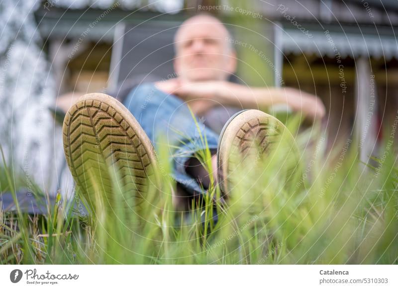 Man in deck chair from frog perspective Deckchair person Lie blades of grass Footwear Summer Grass Meadow Relaxation To enjoy Calm Garden Contentment Nature Day