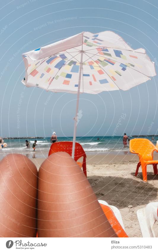 Thigh on beach with umbrella on beach vacation Beach Ocean Sunshade people Beach vacation Summer Orange Plastic chairs Vacation & Travel Summer vacation sunny