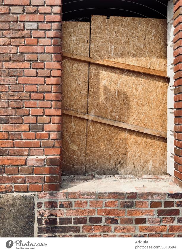 Old brick house, window opening blocked with OSB boards House (Residential Structure) Brick Wall (barrier) Wall (building) Window Wood obstructed barricaded