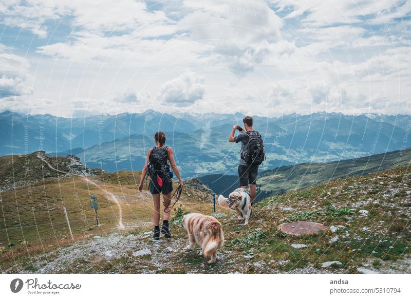 Two hikers with dogs in the mountains Landscape Hiking Nature Dog Adventure High mountain region Mountain Exterior shot Vacation & Travel Hiking trip Tourism