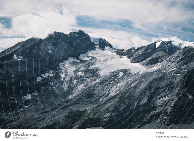 Glaciers in Switzerland mountains Peak Ice Snow High mountain region Rock Gray Waterfall Vantage point Freedom Nature Landscape abyss Cliff Mountain Alps