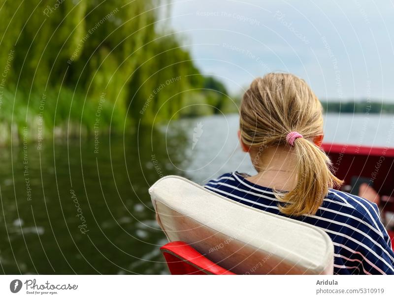 back view | girl sitting in pedal boat on lake with shore Child Girl Pedalo Water Lake Ponytail hairstyle Surface of water Sun bank Beautiful weather Trip