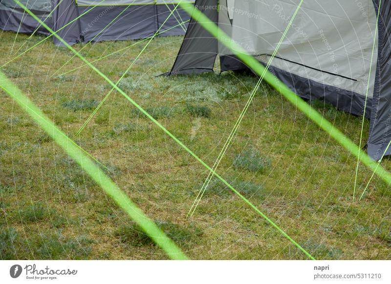 Mission possible: The camping season is open. | Tents and their fastening ropes close together on a meadow. Camping Summer Vacation & Travel Camping site