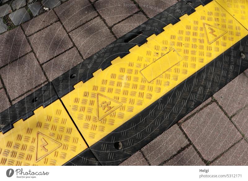 Cable duct as a precaution on the sidewalk cable duct Protection peril Stumbling block Safety Dangerous Signs and labeling Warn Caution Warning label esteem