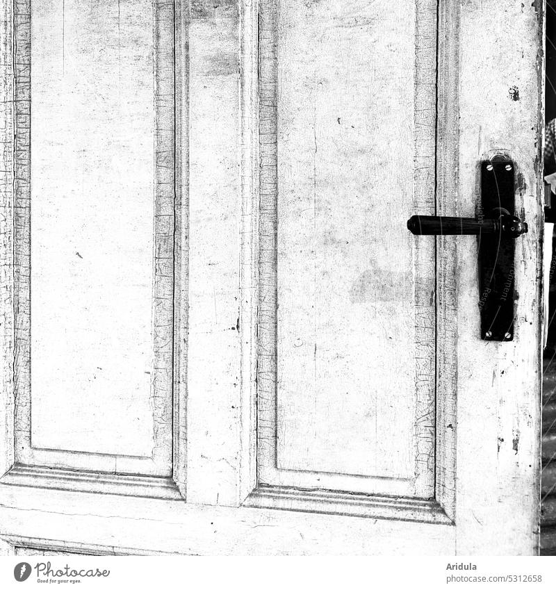 Very old white coffered door with cracks in the paint, door slightly open Old White door handle Black Frame and panel door Wood Colour Varnish Curiosity Detail