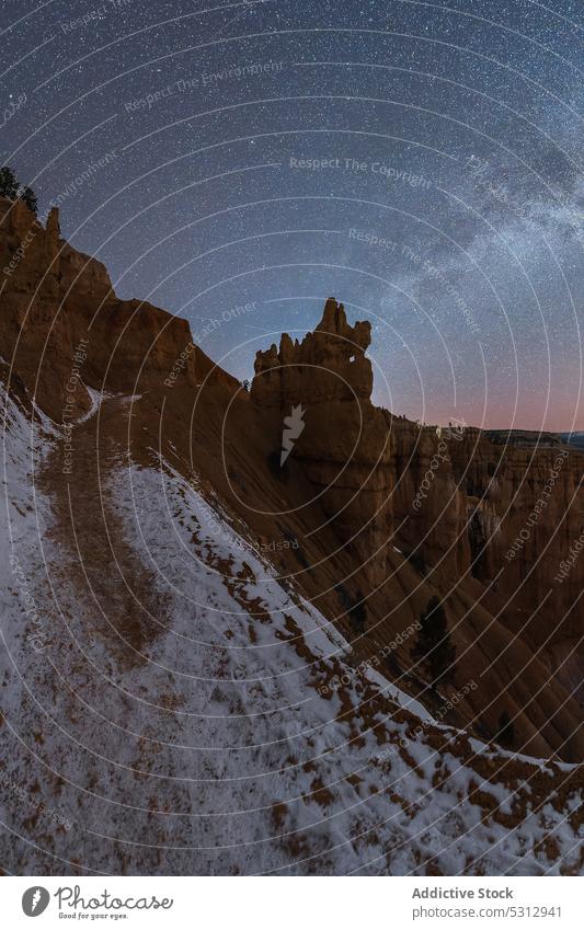 Amazing view of rocky formations in winter at night mountain uneven rough cliff canyon scenery bryce canyon national park nature landscape surface sky star