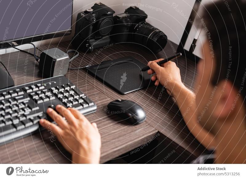 Crop man working on computer and graphics tablet retouche photographer photo camera gadget keyboard using photography draw professional device male digital