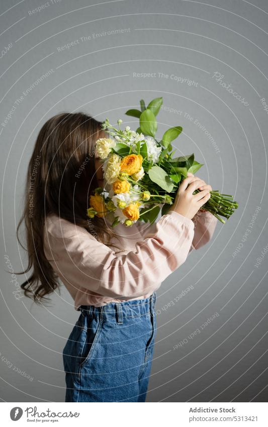 Anonymous girl with bouquet of flowers hide rose bloom bud blossom floral fresh stem delicate plant aroma leaf floristry fragrant natural romantic gift petal