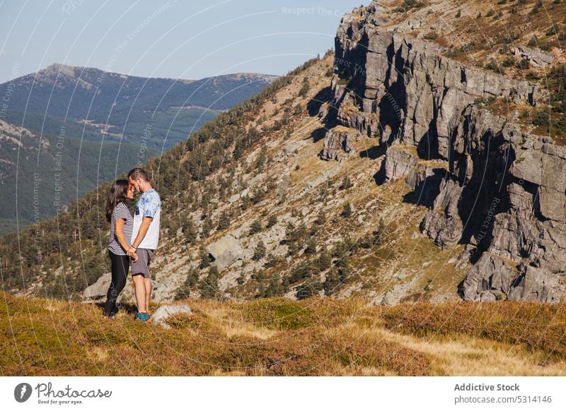 Couple of travelers standing against mountain slope couple holding hands love relationship romantic nature together summer happy rocky soria spain grass enjoy