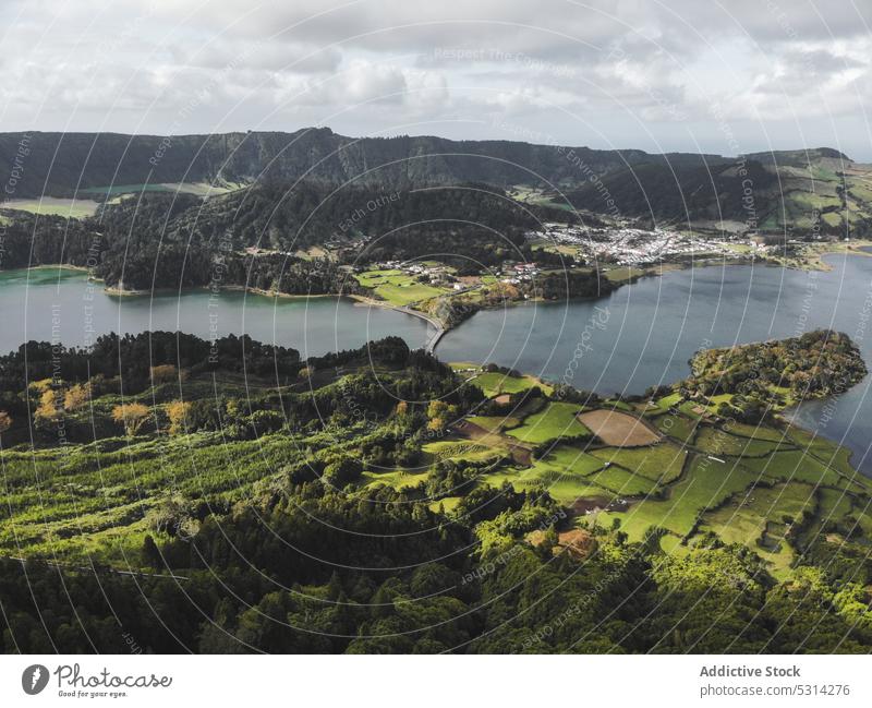 Picturesque landscape of green agriculture fields and settlements nature mountain countryside cloudy scenery azores region valley picturesque plantation scenic