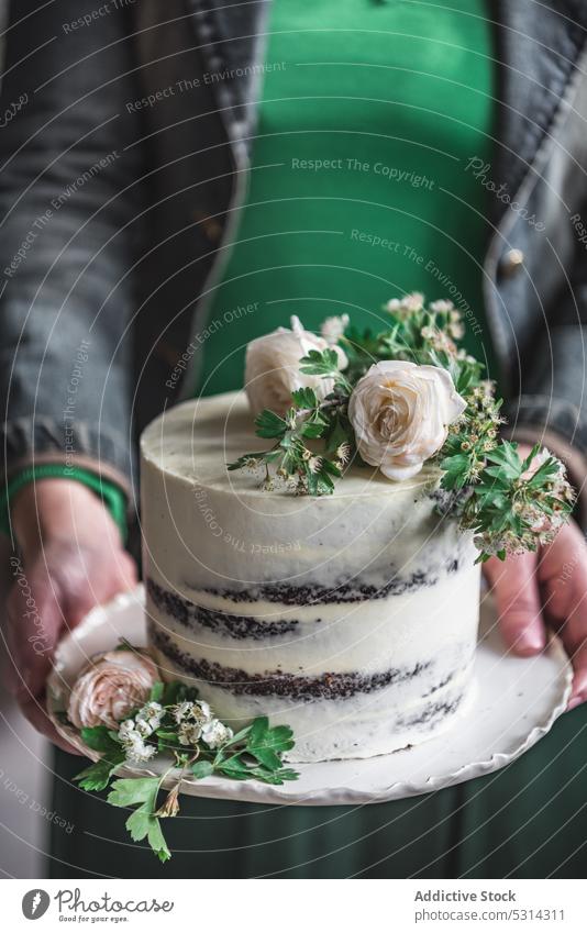 Crop woman with delicious wedding cake flower celebrate demonstrate show dessert event sweet festive female tasty fresh style pastry appetizing elegant