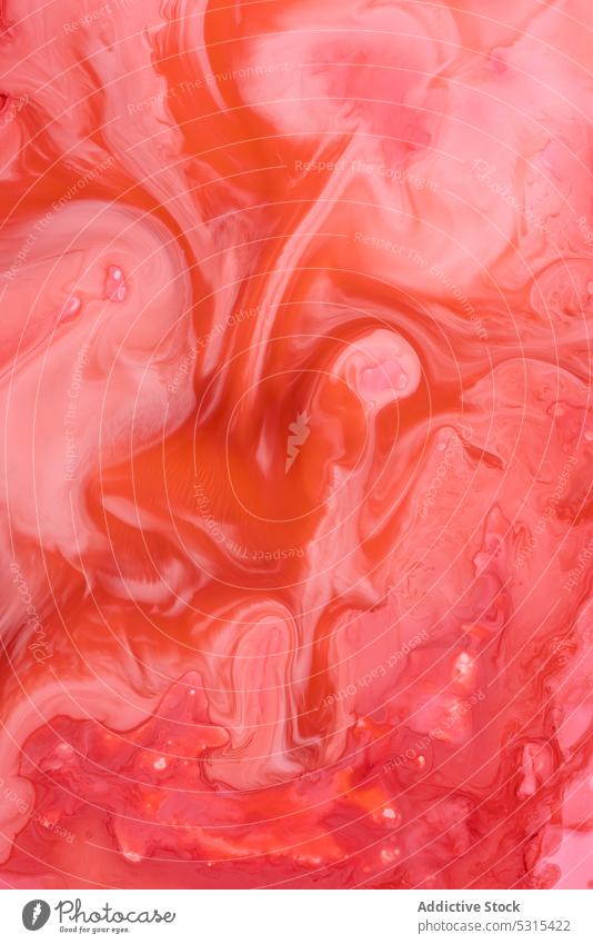 Abstract flow of liquid paints in mix spills art dye abstract bright pigment drop colorful multicolored swirl ornament vivid vibrant water orange blot wet craft