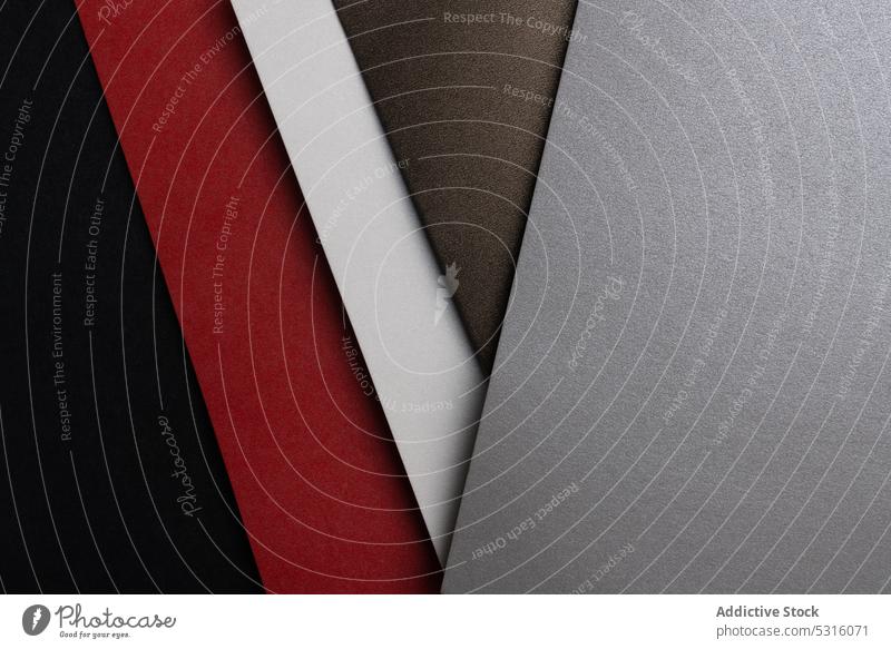 Arranged sheets of colorful carton layout black brown red white glitter background tone blocking shade cardboard surface material design texture grey trend