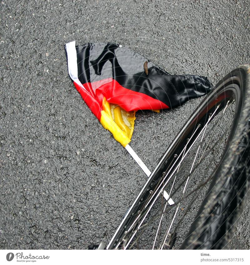 something with soccer Flag flag Street Bicycle Asphalt Crumpet Lie Wet jettisoned Bird's-eye view Perspective out In transit German Colours black red yellow