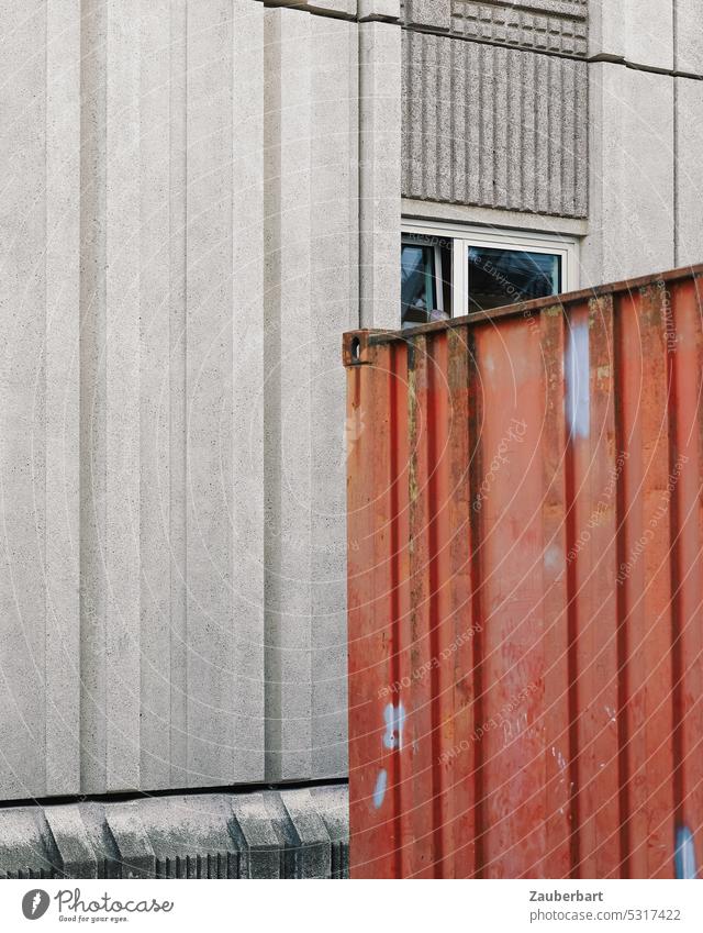 Red container in front of gray concrete wall of apartment building in prefabricated construction Container Wall (building) Concrete Concrete wall